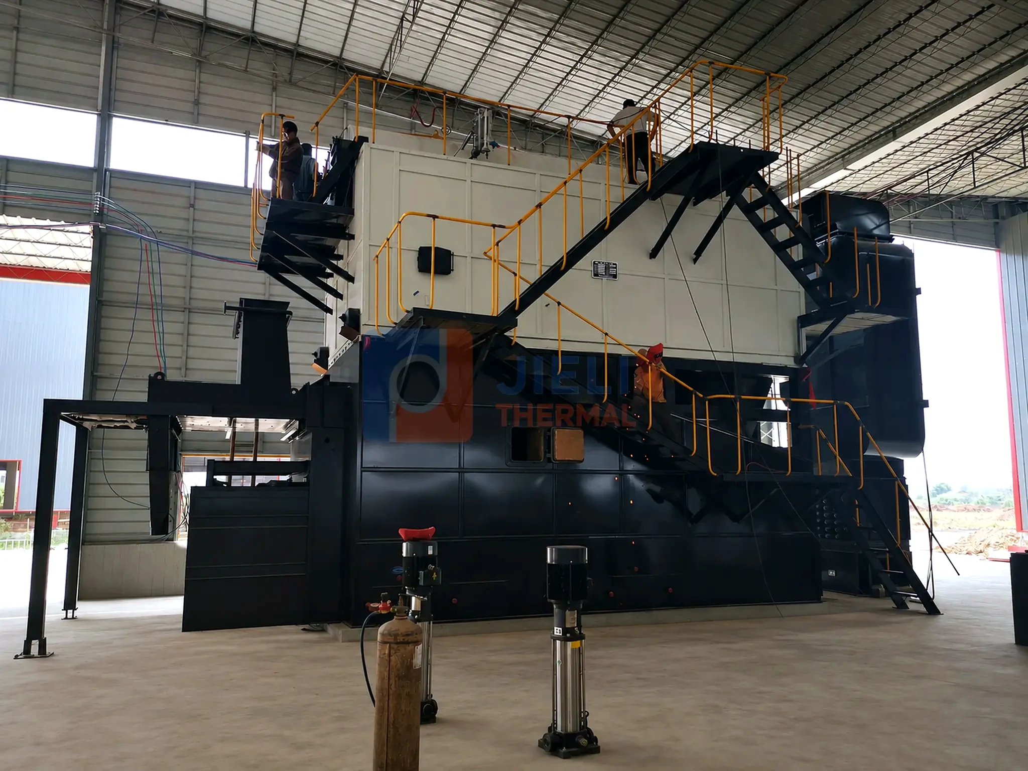Biomass-fired steam boiler — installed side view with process piping