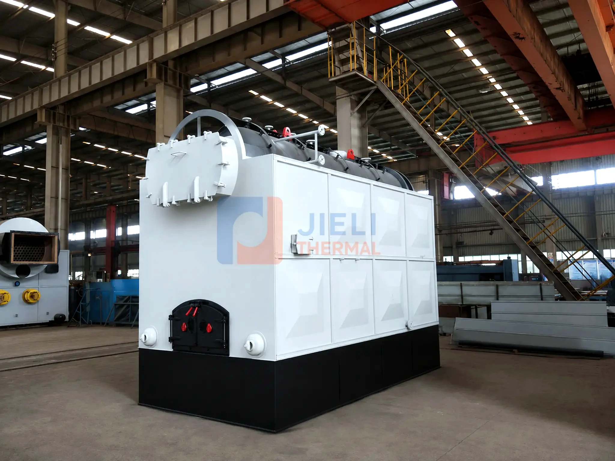 Biomass-fired steam boiler — front view in the production workshop