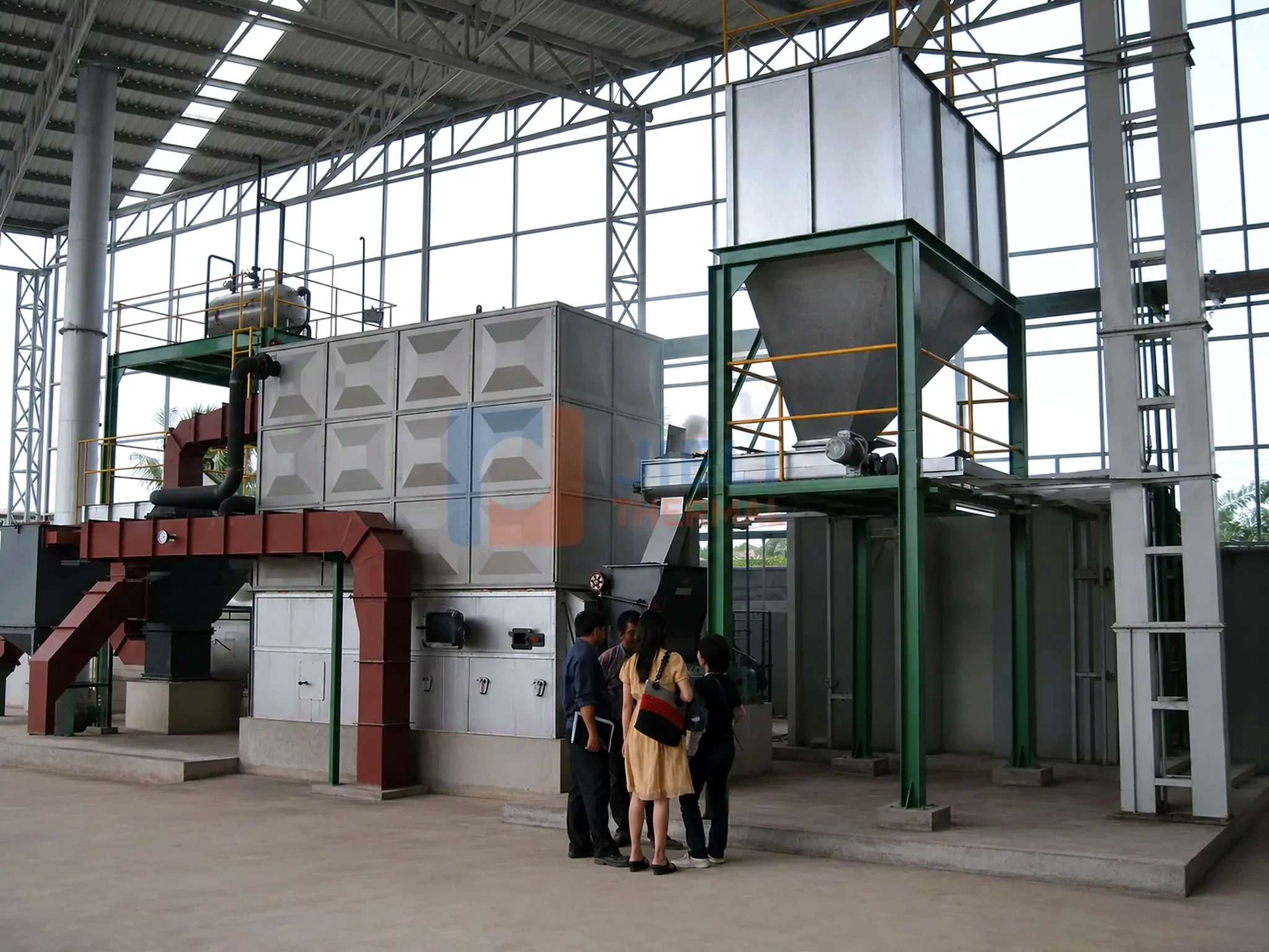 Biomass-fired thermal oil heater — installed system with fuel silo and furnace