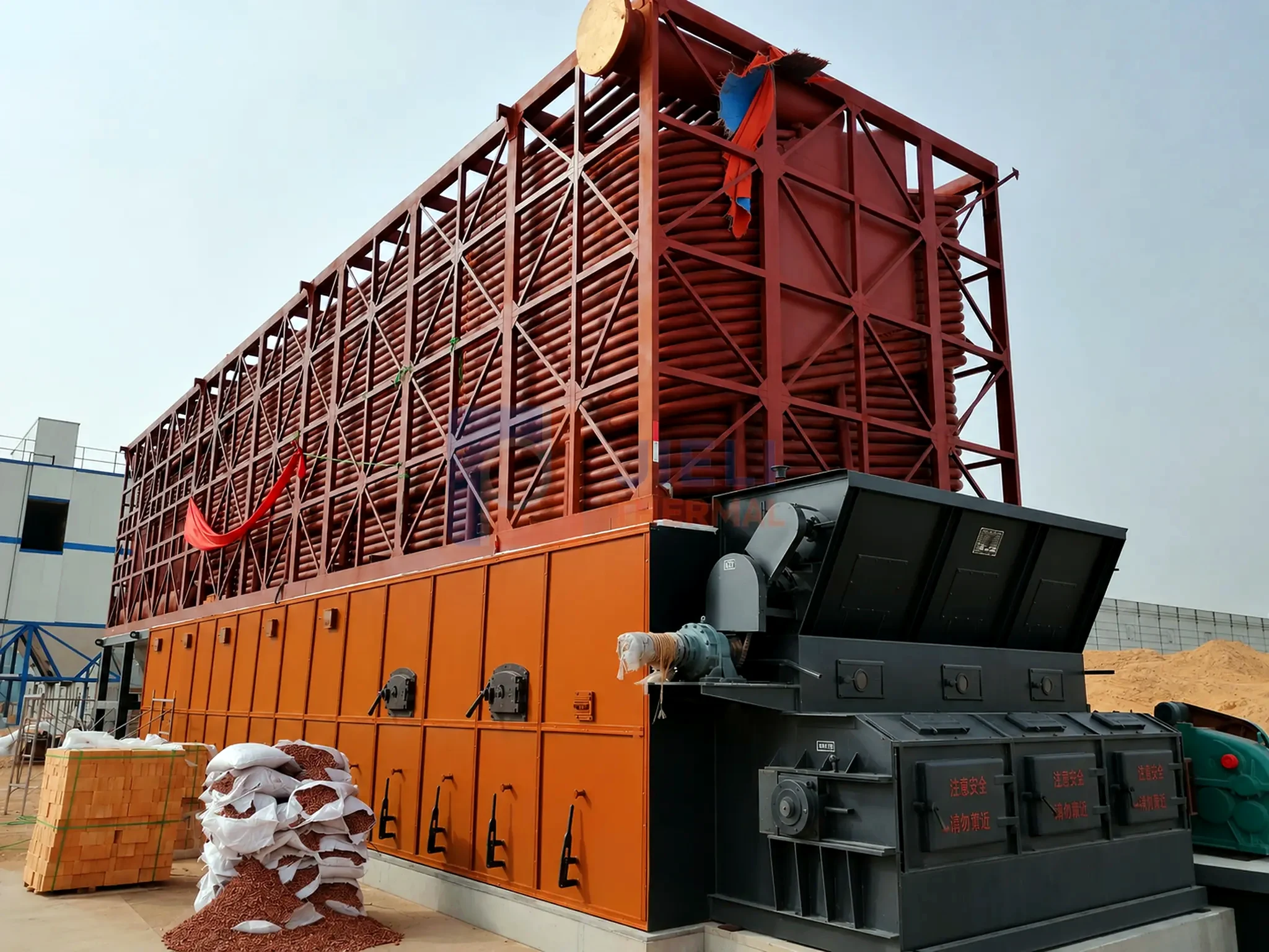 Solid-fuel thermal oil heater — complete industrial installation with draft and dust-control equipment
