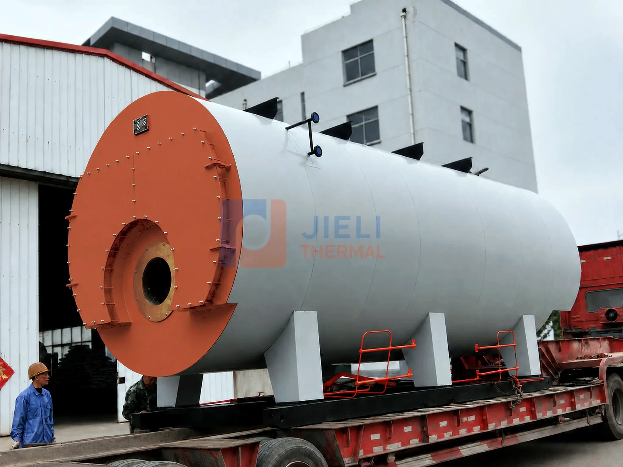 Front-end view of a gas / oil-fired steam boiler shell on a flatbed