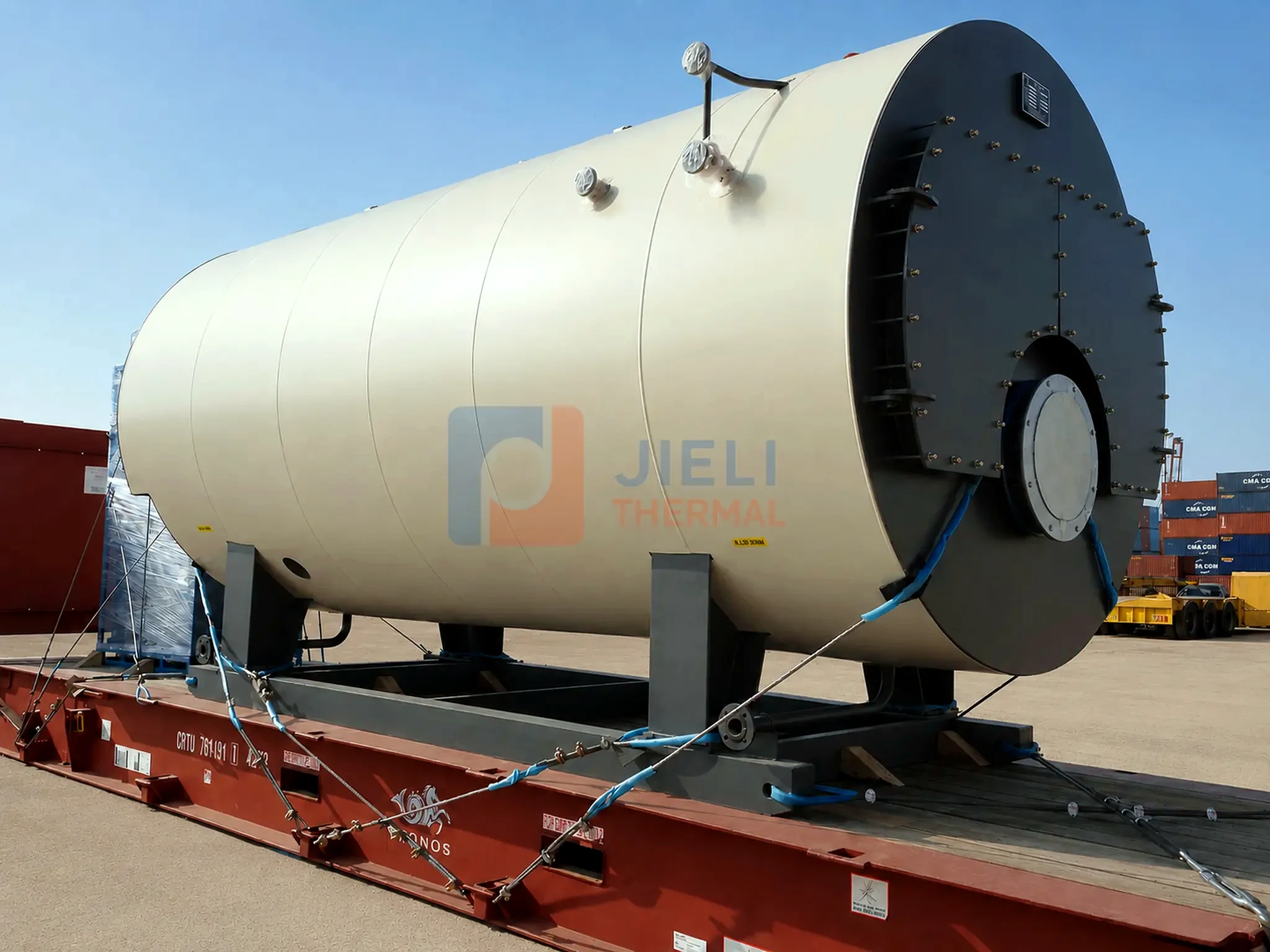 Side view of a packaged gas / oil steam boiler secured to a truck