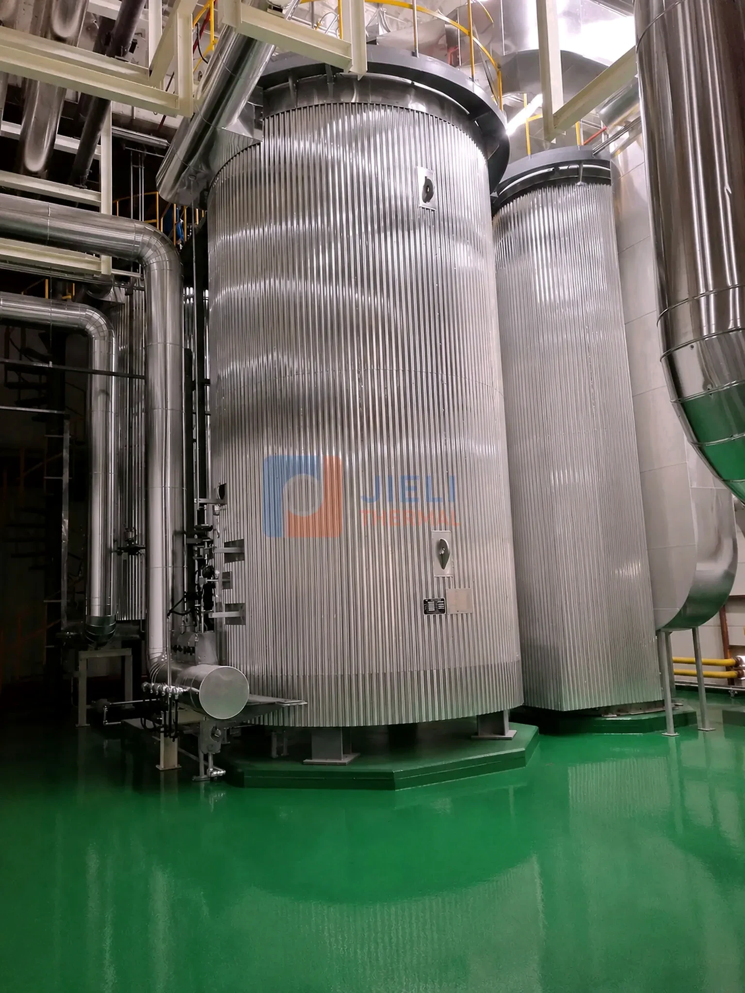 Installed thermal oil process vessels and insulated piping in an industrial heating system