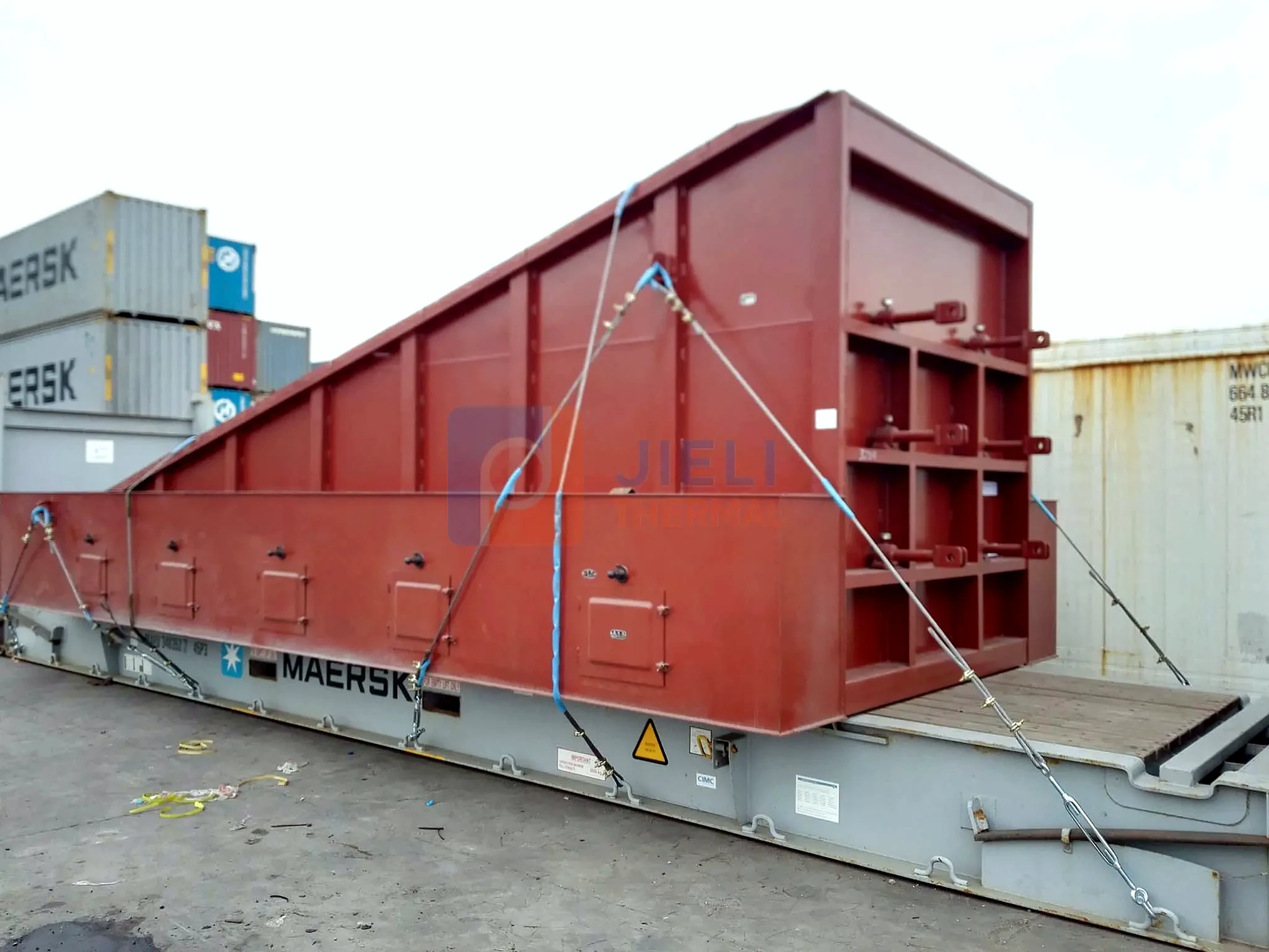 Industrial boiler export delivery — chain-grate boiler module secured on a flat-rack container