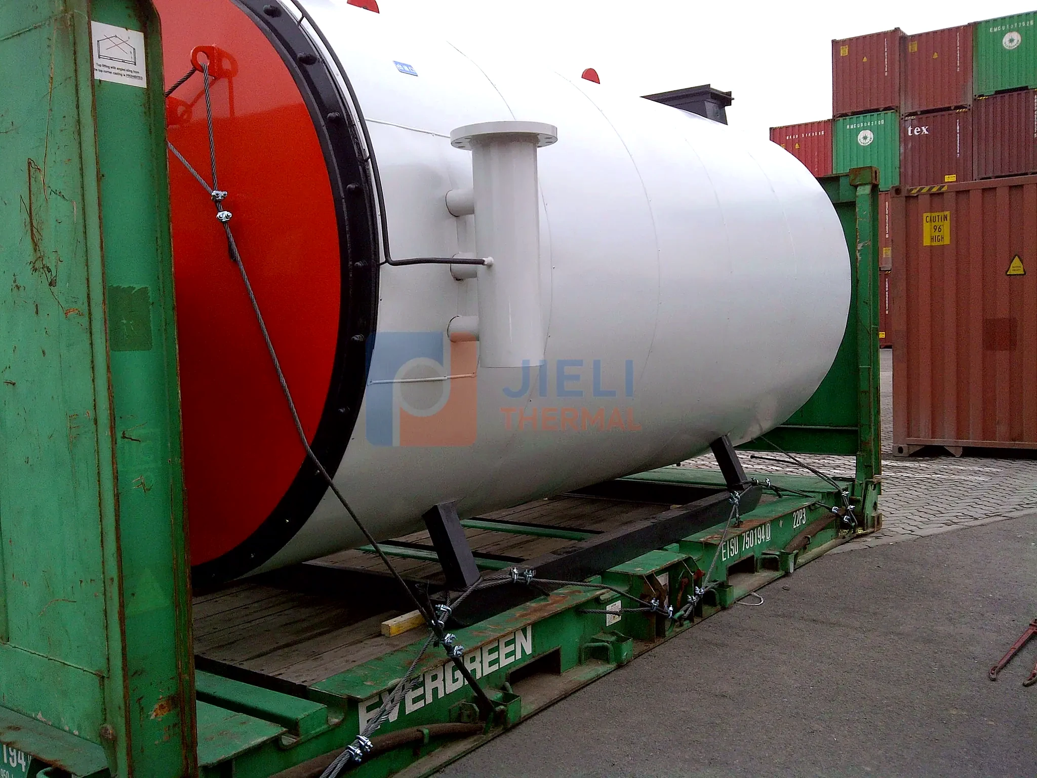 Industrial boiler export delivery — gas-fired steam boiler loaded into a shipping container