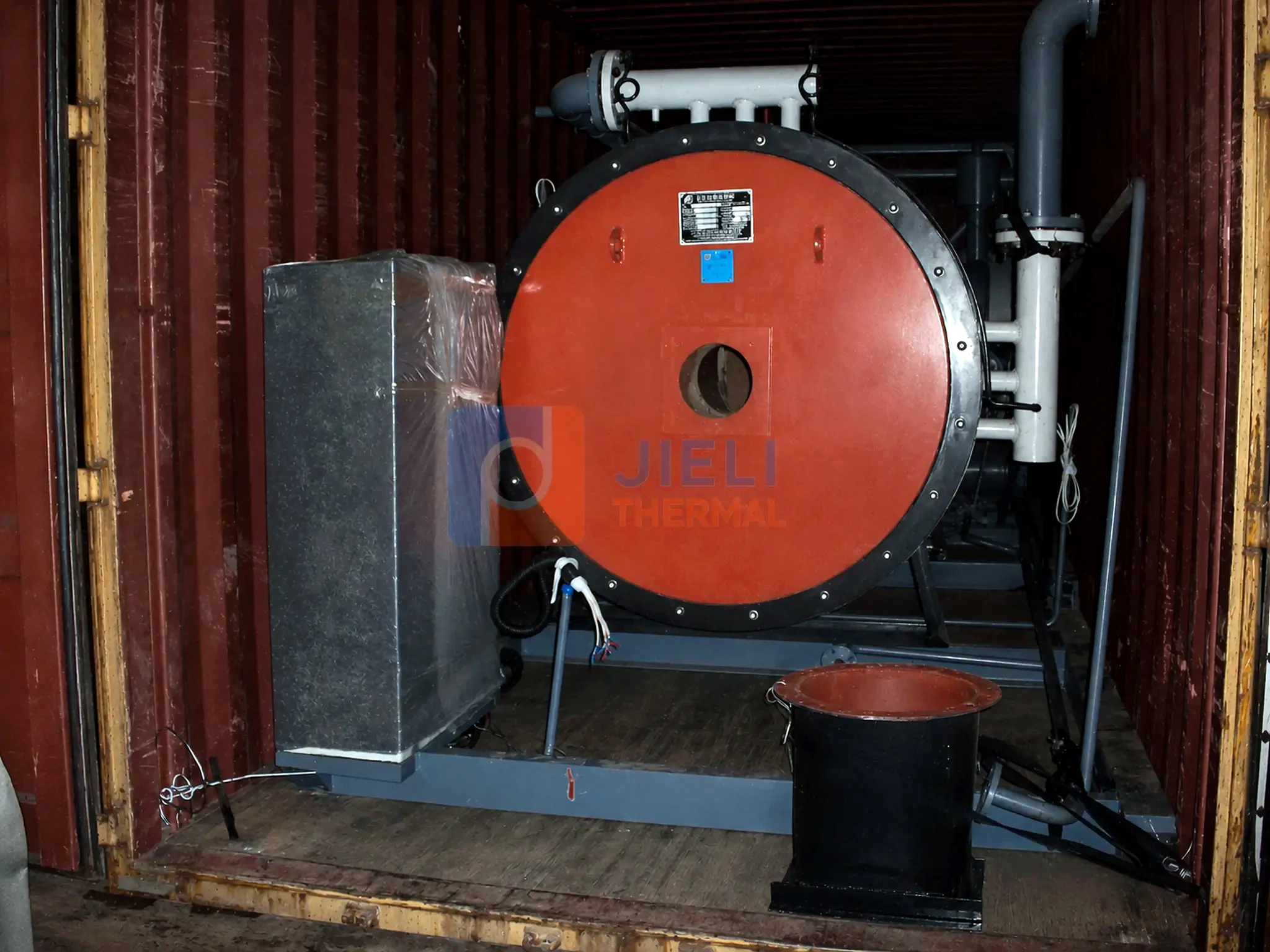 Industrial boiler export delivery — gas-fired thermal oil heater secured inside a container