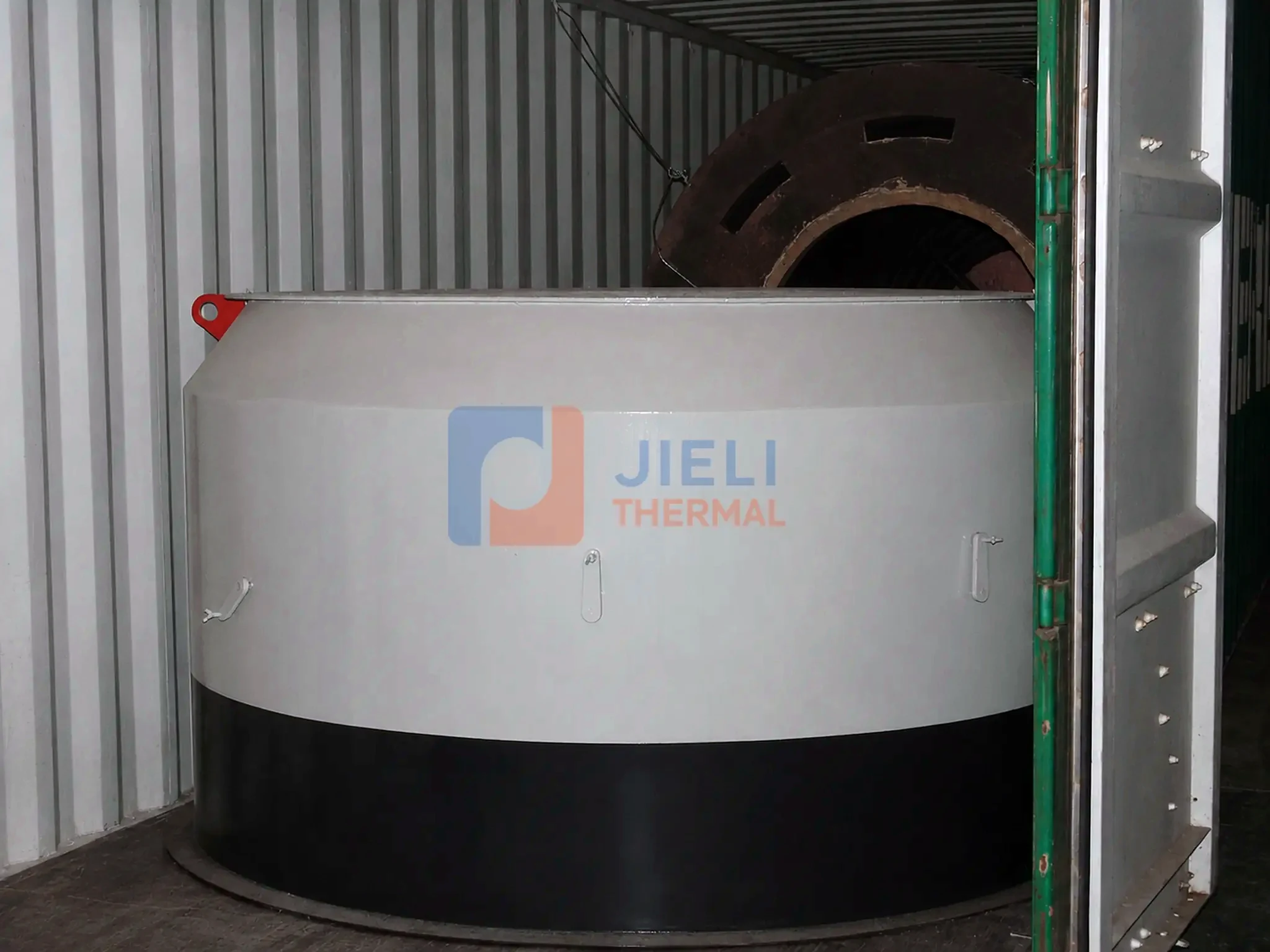 Industrial boiler export delivery — insulated thermal oil heater positioned inside a container