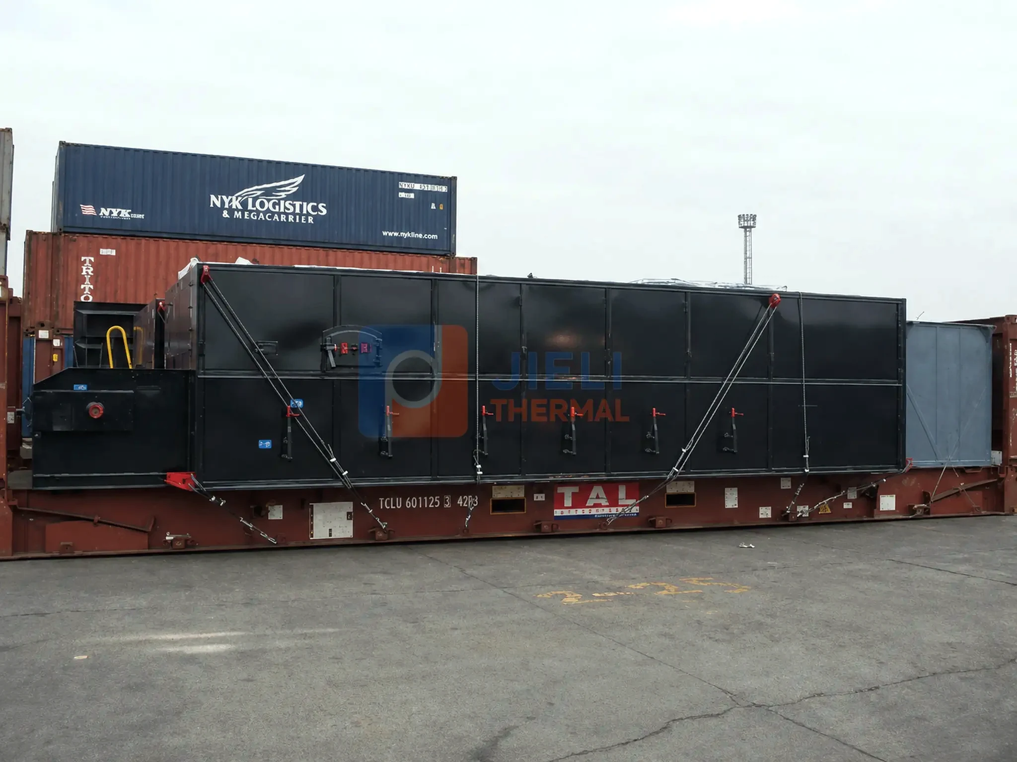 Industrial boiler export delivery — large boiler package secured for open-top export transport