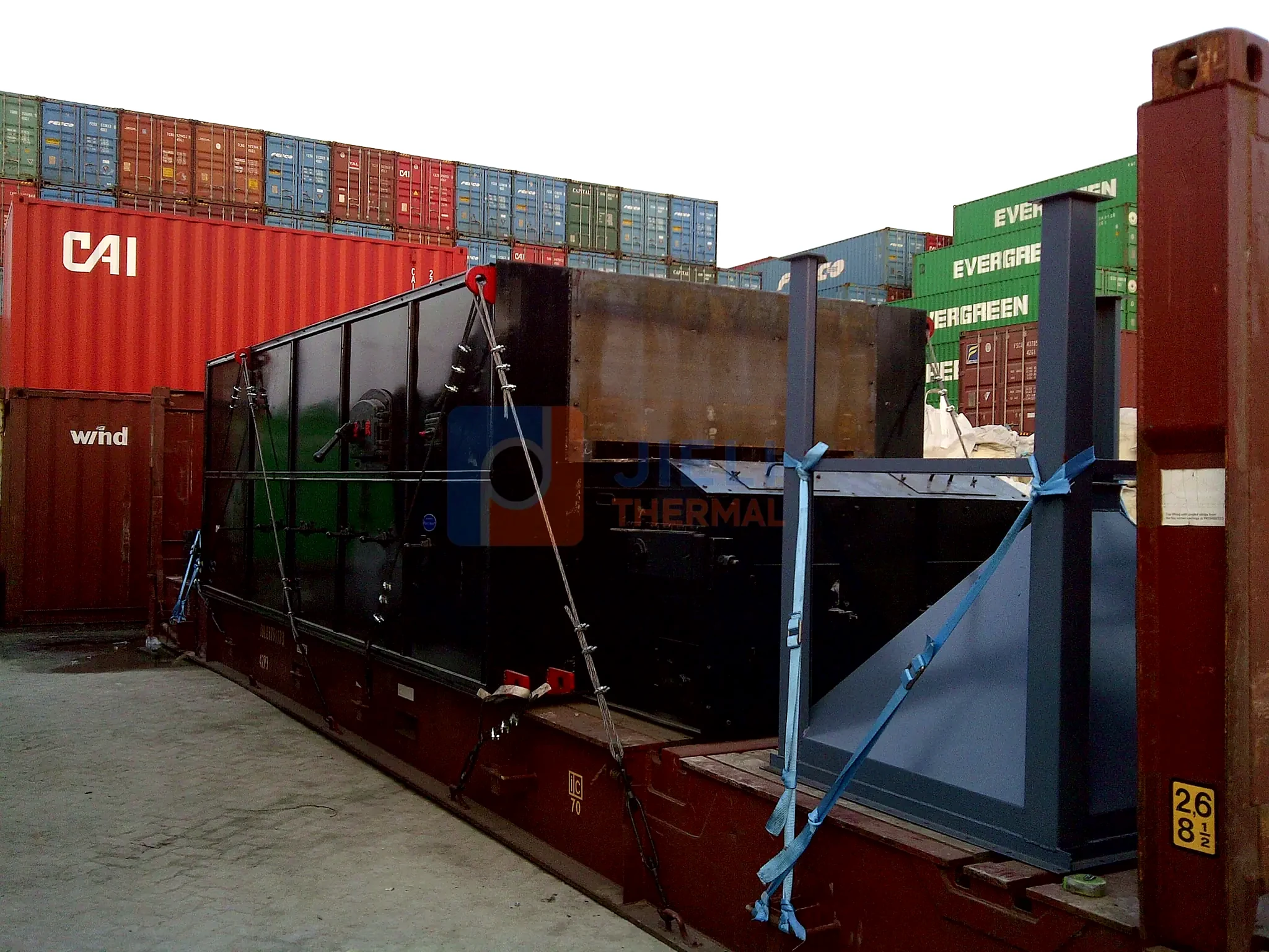 Industrial boiler export delivery — solid-fuel grate system loaded for container delivery