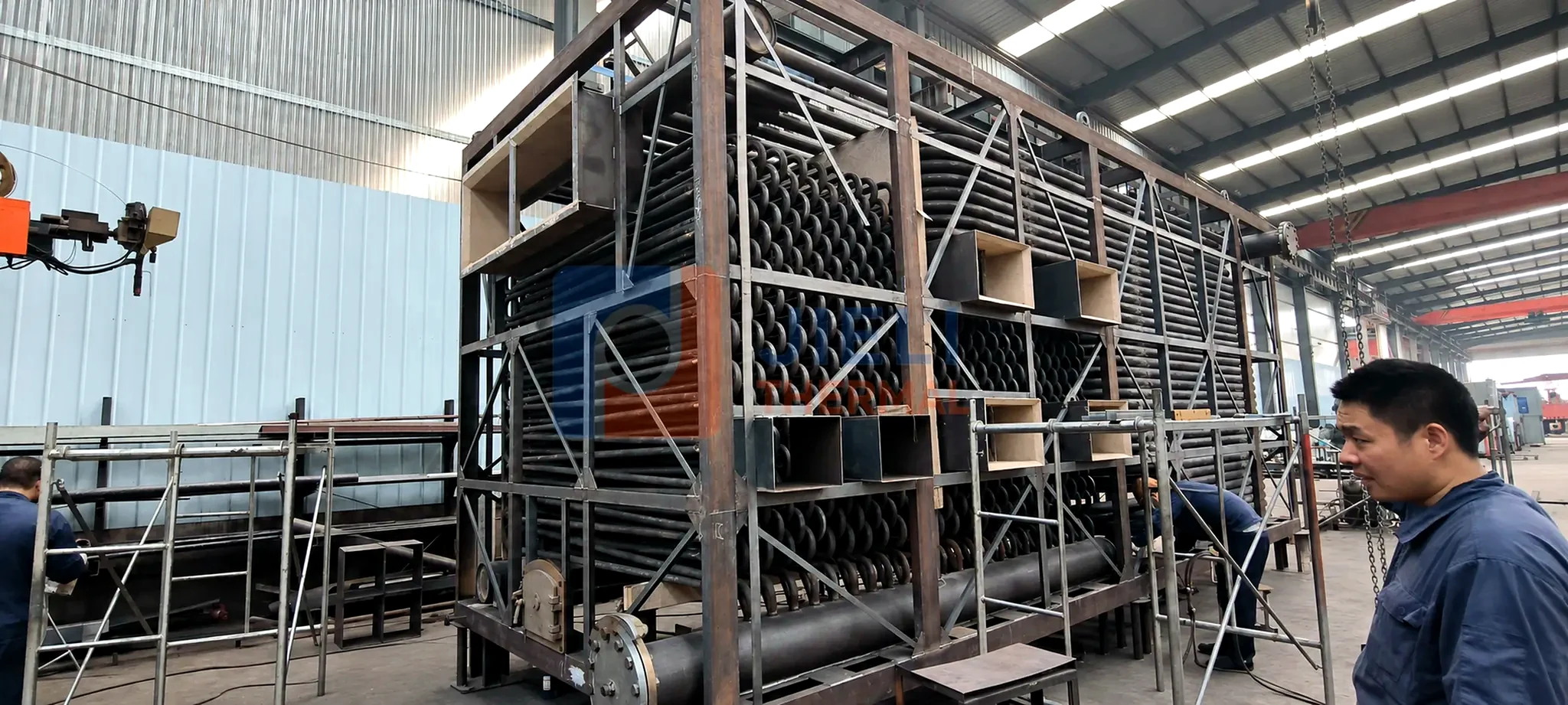 JIELI THERMAL boiler manufacturing — heat-transfer coil assembly in the manufacturing workshop