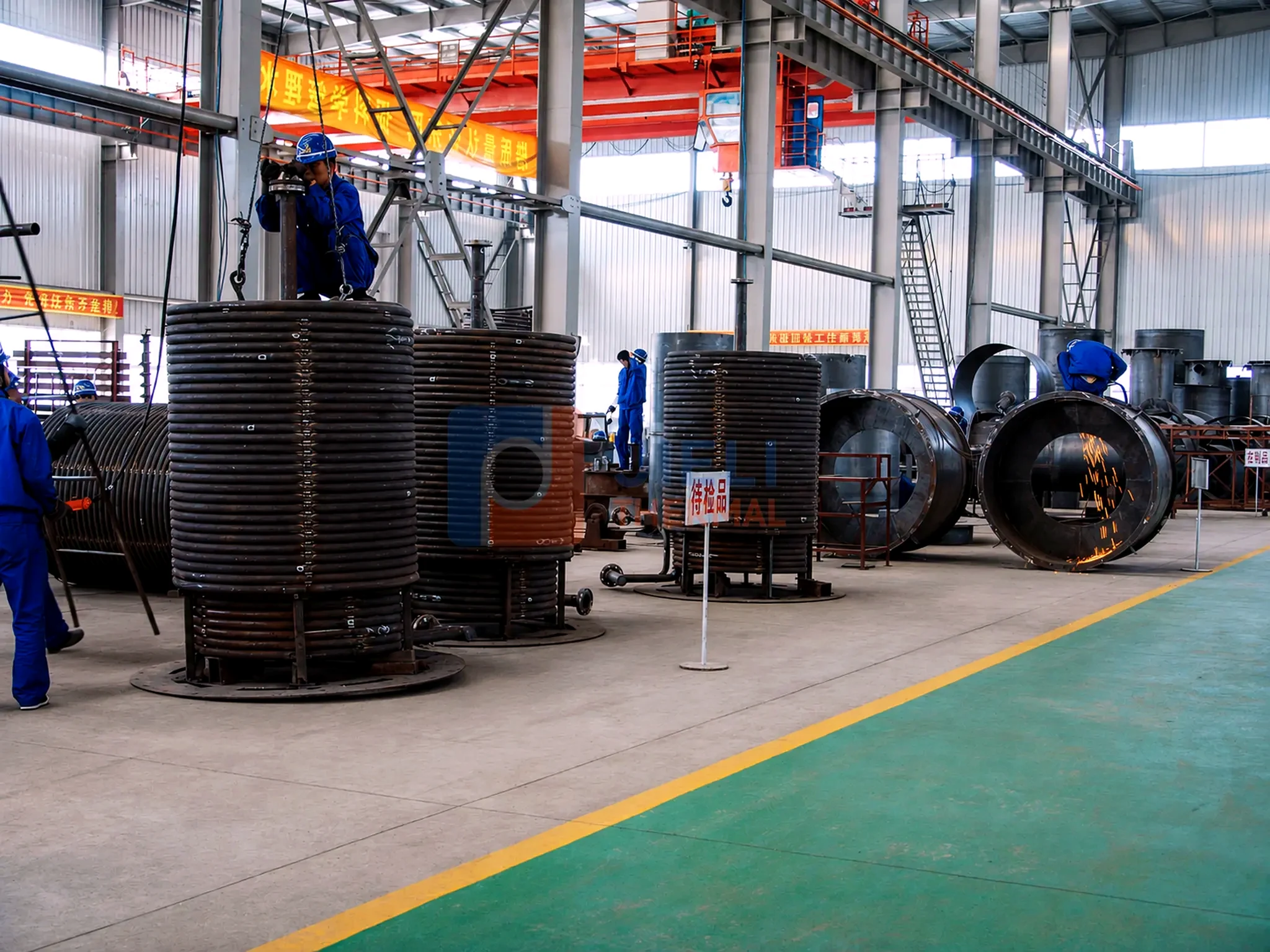JIELI THERMAL boiler manufacturing — thermal-oil heater coils in the fabrication workshop