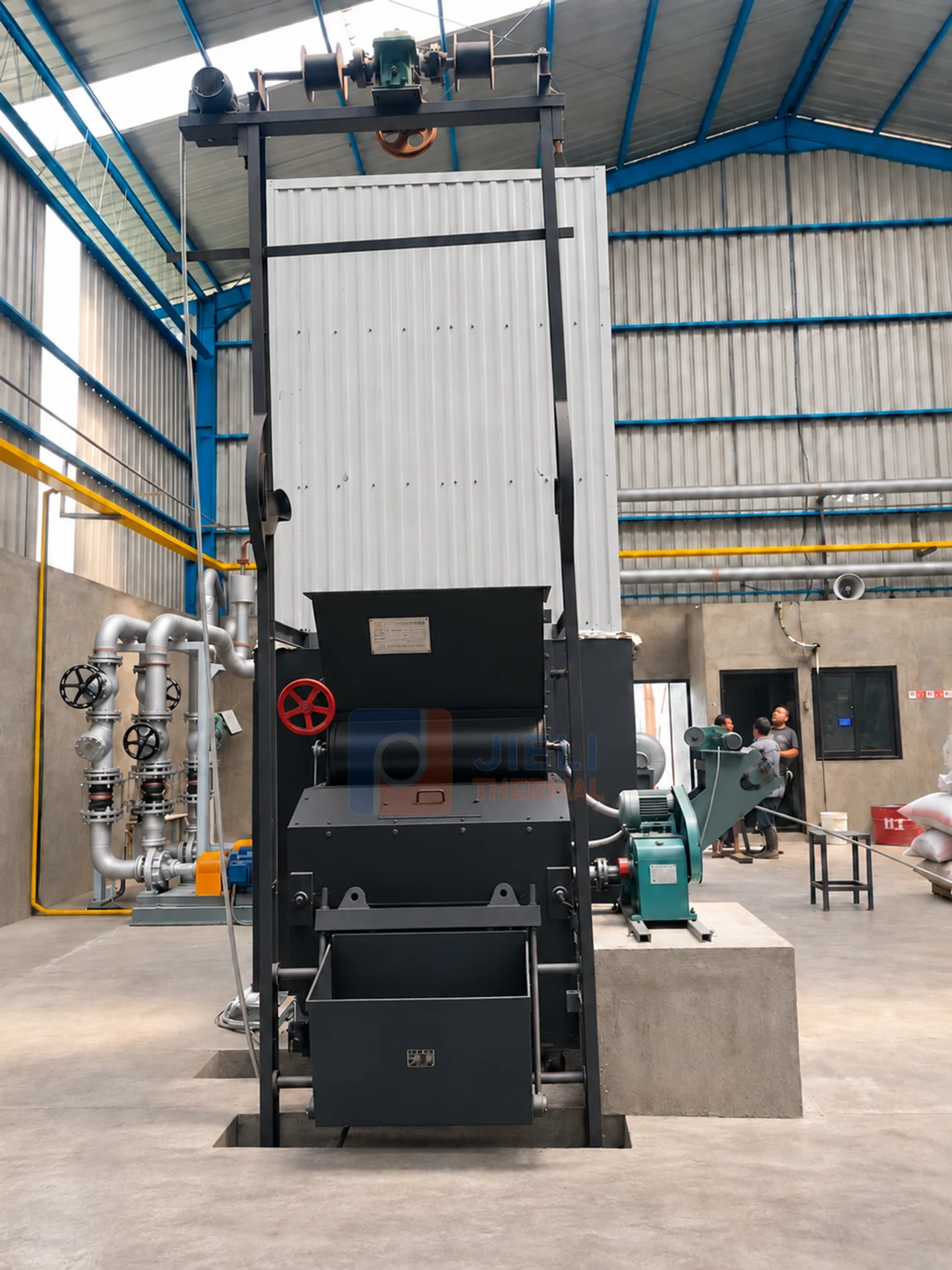Front view of the installed palm kernel shell thermal oil heater and fuel-handling equipment in Indonesia